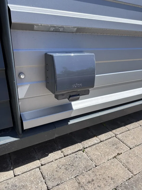 A weatherproof outdoor connection unit fitted to cladding
